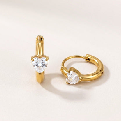 Sweetheart Spark Huggies Gold: hypoallergenic huggie hoop earrings, shown front and side on a soft stone background