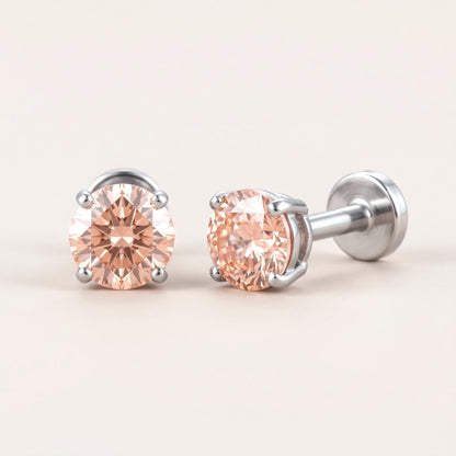The Birthstone Flat Back Studs Silver in Champagne Pink Ruby: hypoallergenic kids' flat back stud earrings, shown front and side on a soft stone background
