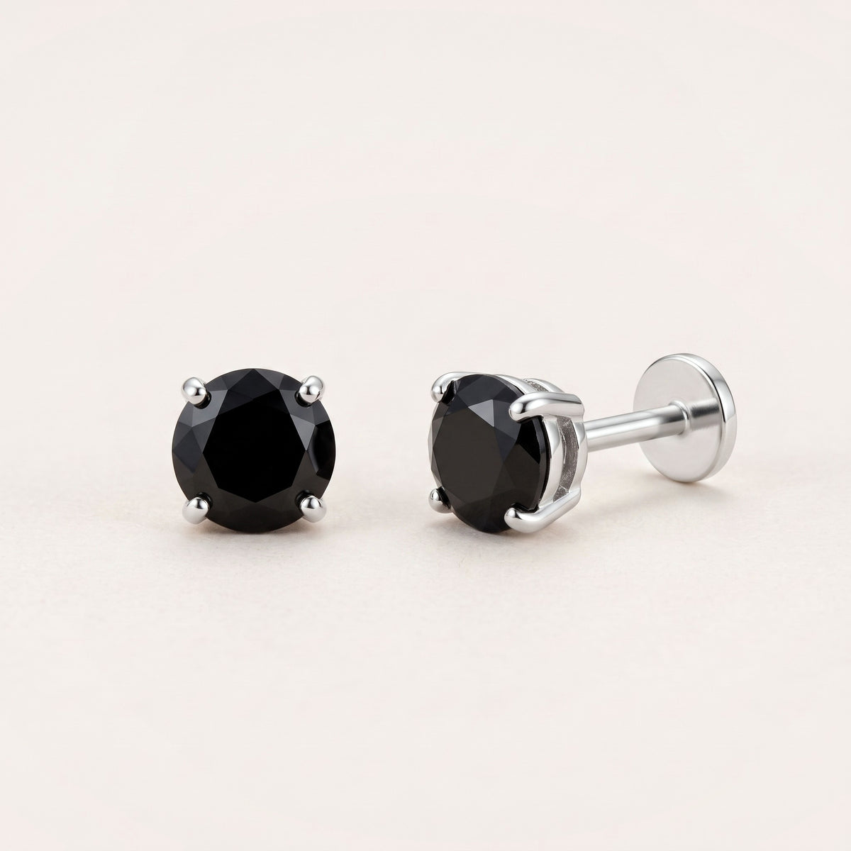 The Birthstone Flat Back Studs Silver in Onyx: hypoallergenic kids' flat back stud earrings, shown front and side on a soft stone background