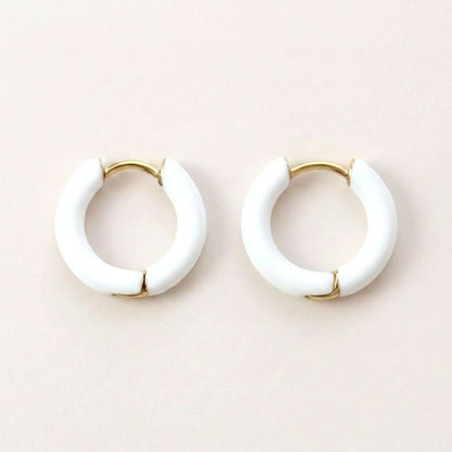 Enamel Pop Hoops White: hypoallergenic kids' huggie hoop earrings, shown front and side on a soft stone background