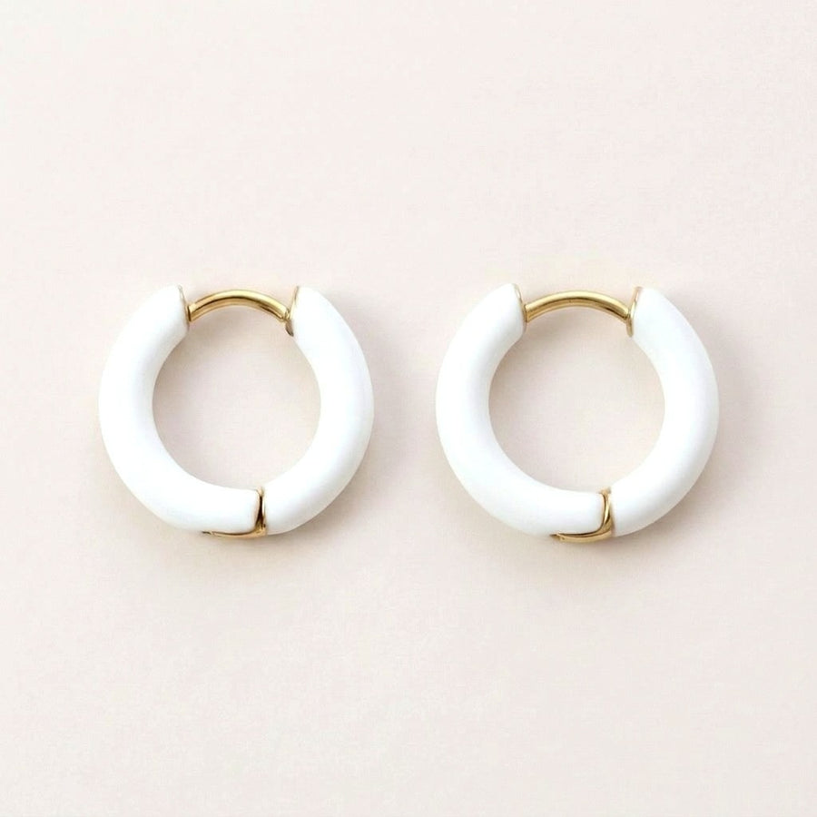 Enamel Pop Hoops White: hypoallergenic kids' huggie hoop earrings, shown front and side on a soft stone background