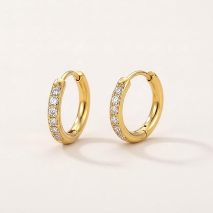 Gold Glow Band CZ Diamond Huggie: hypoallergenic kids' huggie hoop earrings, shown front and side on a soft stone background