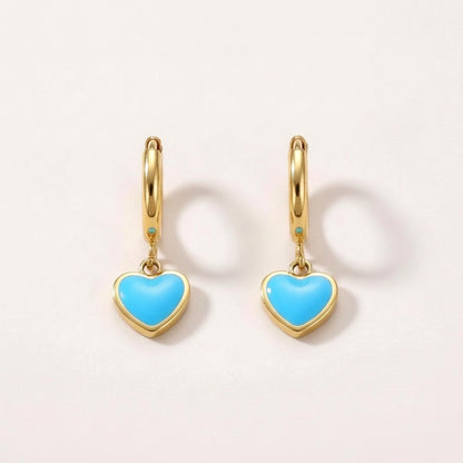 Heart Huggies Gold: hypoallergenic kids' huggie hoop earrings, shown front and side on a soft stone background