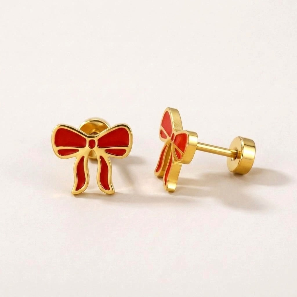 Red Bow Flat Back Studs: hypoallergenic kids' flat back stud earrings, shown front and side on a soft stone background