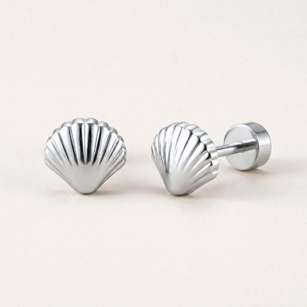 Seashell Flat Back Stud Silver: hypoallergenic kids' flat back stud earrings, shown front and side on a soft stone background
