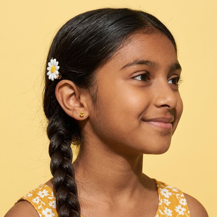 November birthstone earrings: citrine colour flat back stud worn by a smiling girl