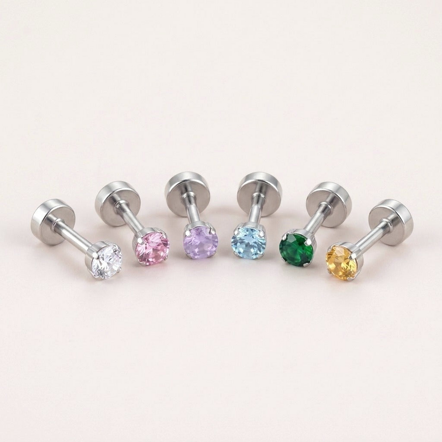 The Birthstone Flat Back Studs Silver: hypoallergenic kids' flat back stud earrings in birthstone colours, on a soft stone background